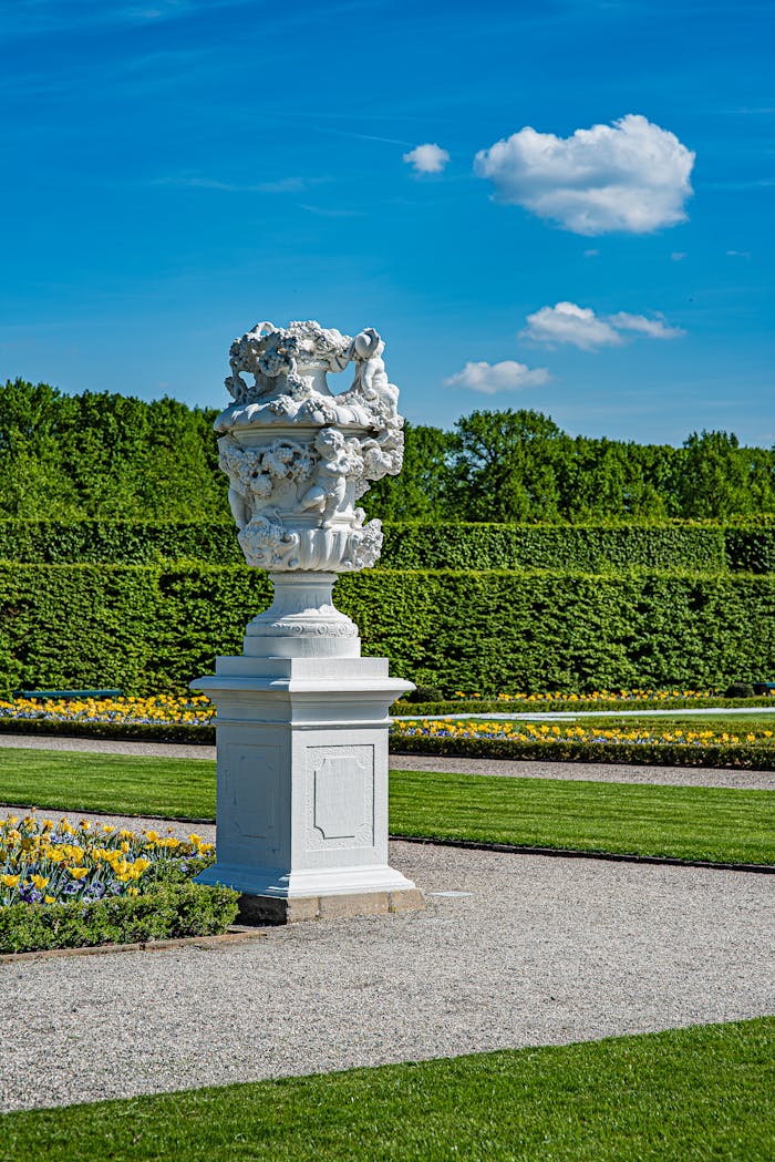 Stunning marble sculpture in Hannover's Herrenhausen Gardens, capturing classic European garden design.