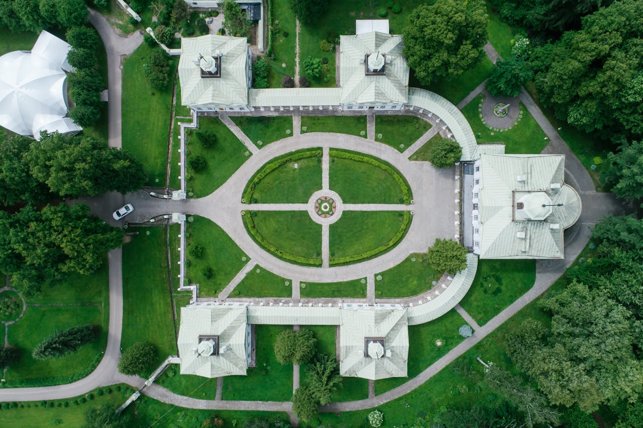 Beautiful aerial view of a historical estate's perfectly manicured gardens and pathways.